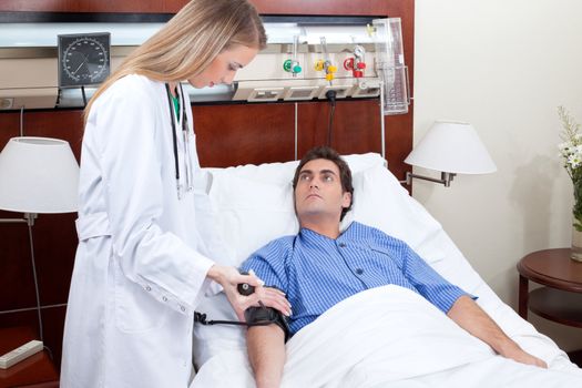 Doctor checking the blood pressure of the patient in hospital