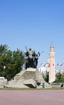 Monument of Mustafa Kemal Ataturk in Antalya, in background Yivli minaret