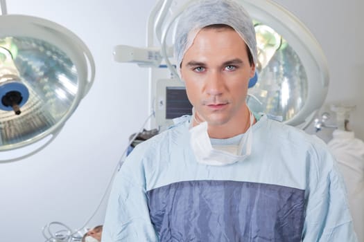 Close-up portrait of smart confident young male surgeon