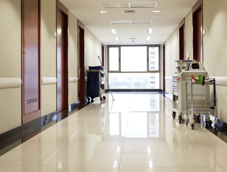 Interior of clean reflective empty hallway of hospital