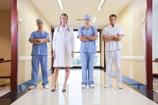 Team of doctor and nurse standing in hallway of hospital