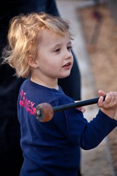 Cute little European girl having fun on playground in a park.