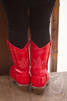 Walking around in red cowboy boots.
