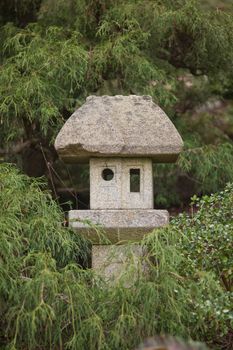 Old Japanese stone lantern in a garden.