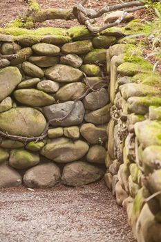 Wall made of stones in traditional Japanese garden.