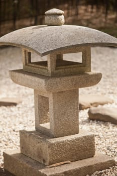 Old Japanese stone lantern in a garden.