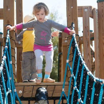 Having fun at playground in the park on sunny afternoon.