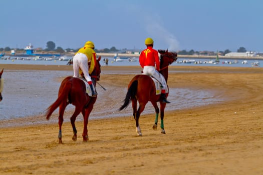 SANLUCAR DE BARRAMEDA, CADIZ, SPAIN - AUGUST 11: Unidentified rider at the start of race horses on Sanlucar de Barrameda beach on August 11, 2011 in Sanlucar de Barrameda, Cadiz, Spain.