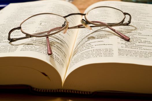 Bible book in the Swedish languageand glasses taken as macro