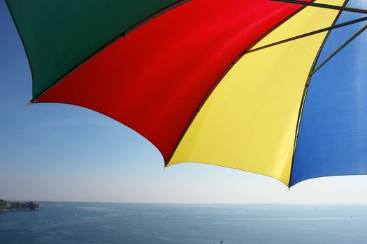 colorful parasol at the ocean against sky