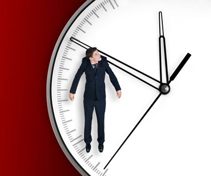 Businessman hangs on an arrow of clock, isolated on red background