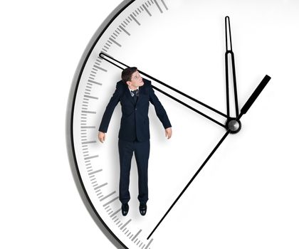 Businessman hangs on an arrow of clock, isolated on white background