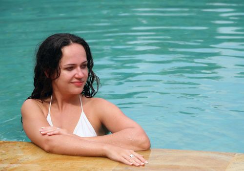 Beautiful woman enjoying summer in the pool