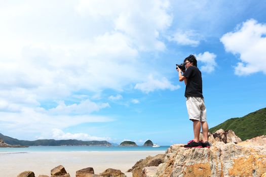 Photographer taking photo on beach