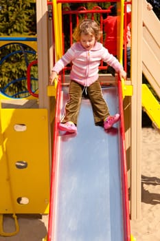 Having fun playing on playground on sunny morning.