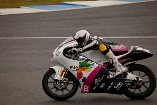JEREZ DE LA FRONTERA, SPAIN - NOV 20: 125cc motorcyclist Miguel Poyatos Alarcon races in the CEV championship on Nov 20, 2010, in Jerez de la Frontera, Spain