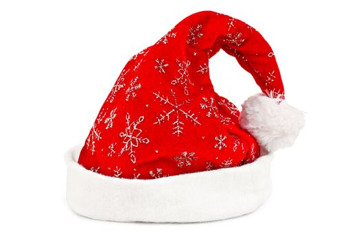 Red cap with a pattern of silver snowflakes, white fuzzy fringe and a white fur brush isolated on white background