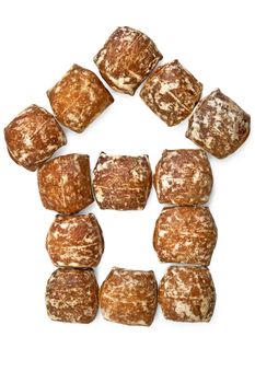 Gingerbread with white icing put in the form of the house is isolated on a white background