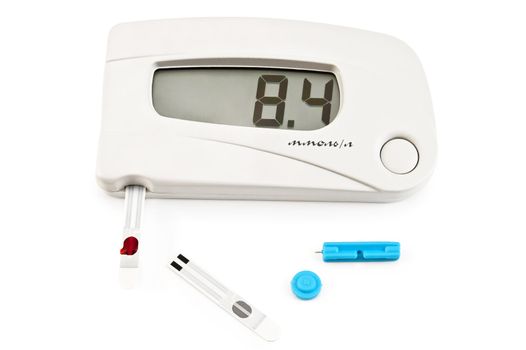 White instrument for measuring glucose levels with test strips, a drop of blood and needles isolated on a white background