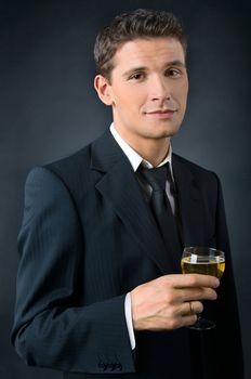 Portrait of a beautiful man with a glass of champagne