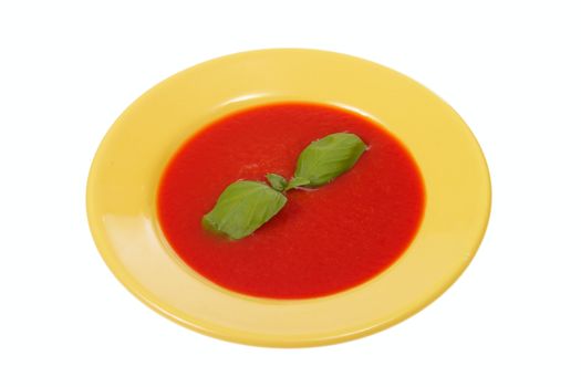 tomato soup in yellow plate, photo on white
