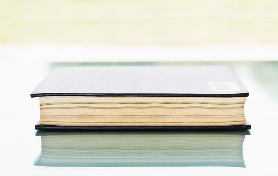 Blank book with black cover on background