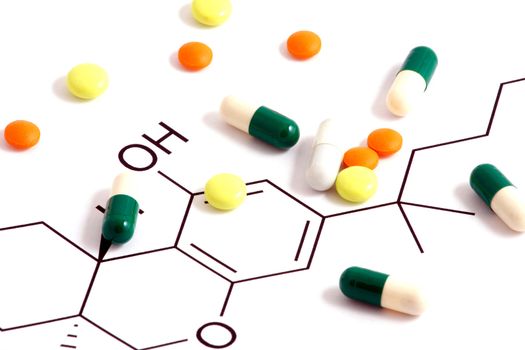 Pills of many shapes and colors grouped together
