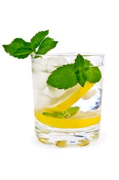 Iced water, lemon slices, mint in a glass beaker isolated on white background