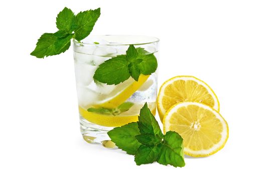 Iced water, lemon slices, mint in a glass beaker, sliced ??lemon on the table isolated on white background