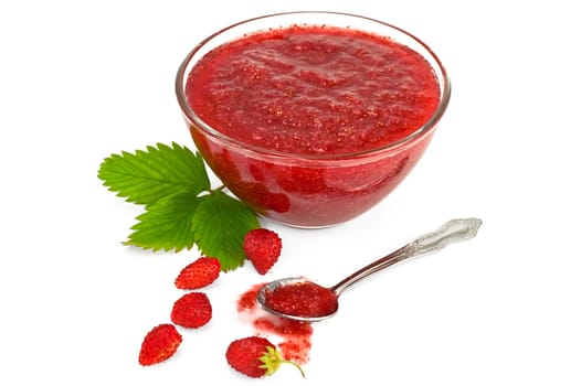 Strawberry jam in a glass cup, a few strawberries with green leaf, a spoonful of jam isolated on a white background