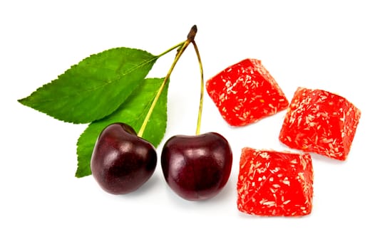Three red jelly with two cherries and green leaves isolated on white background