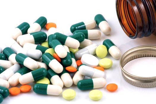Pills of many shapes and colors grouped together
