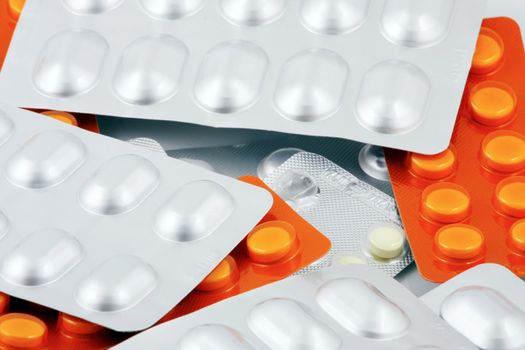 Pills of many shapes and colors grouped together