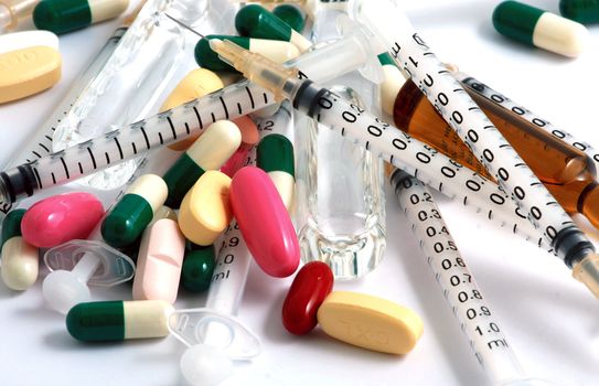Pills of many shapes and colors grouped together