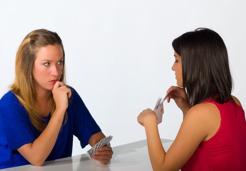 Blond and brunette in  a serious poker confrontation