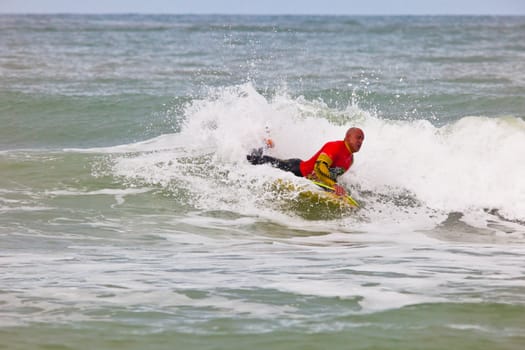 SAN FERNANDO, CADIZ, SPAIN - FEB 19: Unknown bodyboader going to the water on the 2nd championship of Surf and BodyBoard Impoxibol on Feb 19,2011 on the beach of Camposoto of San Fernando, Cadiz, Spain
