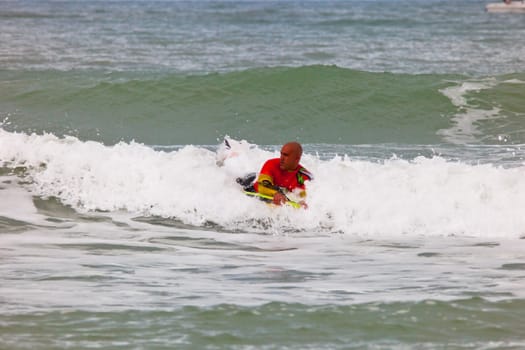 SAN FERNANDO, CADIZ, SPAIN - FEB 19: Unknown bodyboader going to the water on the 2nd championship of Surf and BodyBoard Impoxibol on Feb 19,2011 on the beach of Camposoto of San Fernando, Cadiz, Spain