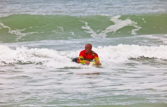 SAN FERNANDO, CADIZ, SPAIN - FEB 19: Unknown bodyboader going to the water on the 2nd championship of Surf and BodyBoard Impoxibol on Feb 19,2011 on the beach of Camposoto of San Fernando, Cadiz, Spain