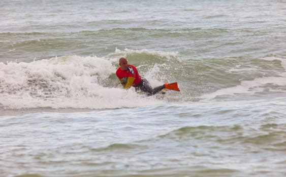 SAN FERNANDO, CADIZ, SPAIN - FEB 19: Unknown bodyboader going to the water on the 2nd championship of Surf and BodyBoard Impoxibol on Feb 19,2011 on the beach of Camposoto of San Fernando, Cadiz, Spain