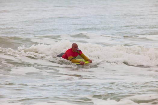 SAN FERNANDO, CADIZ, SPAIN - FEB 19: Unknown bodyboader going to the water on the 2nd championship of Surf and BodyBoard Impoxibol on Feb 19,2011 on the beach of Camposoto of San Fernando, Cadiz, Spain
