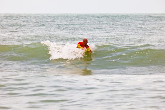 SAN FERNANDO, CADIZ, SPAIN - FEB 19: Unknown bodyboader going to the water on the 2nd championship of Surf and BodyBoard Impoxibol on Feb 19,2011 on the beach of Camposoto of San Fernando, Cadiz, Spain