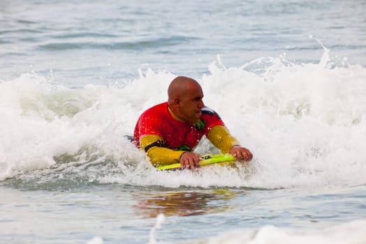 SAN FERNANDO, CADIZ, SPAIN - FEB 19: Unknown bodyboader going to the water on the 2nd championship of Surf and BodyBoard Impoxibol on Feb 19,2011 on the beach of Camposoto of San Fernando, Cadiz, Spain
