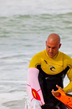 SAN FERNANDO, CADIZ, SPAIN - FEB 19: Unknown bodyboader going to the water on the 2nd championship of Surf and BodyBoard Impoxibol on Feb 19,2011 on the beach of Camposoto of San Fernando, Cadiz, Spain