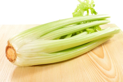 Green celery on a wooden table