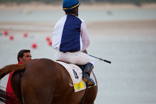 SANLUCAR DE BARRAMEDA, CADIZ, SPAIN - AUGUST 07: Unidentified rider at the start of race horses on Sanlucar de Barrameda beach on  August 07, 2010 in Sanlucar de Barrameda, Cadiz, Spain.