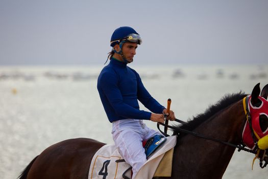 SANLUCAR DE BARRAMEDA, CADIZ, SPAIN - AUGUST 07: Unidentified riders at the start of race horses on Sanlucar de Barrameda beach on  August 07, 2010 in Sanlucar de Barrameda, Cadiz, Spain.