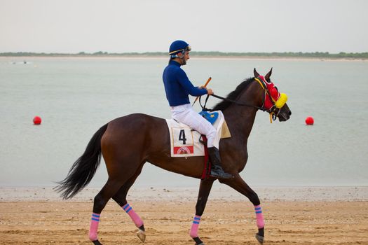 SANLUCAR DE BARRAMEDA, CADIZ, SPAIN - AUGUST 07: Unidentified riders at the start of race horses on Sanlucar de Barrameda beach on  August 07, 2010 in Sanlucar de Barrameda, Cadiz, Spain.