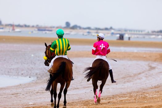 SANLUCAR DE BARRAMEDA, CADIZ, SPAIN - AUGUST 07: Unidentified riders at the start of race horses on Sanlucar de Barrameda beach on  August 07, 2010 in Sanlucar de Barrameda, Cadiz, Spain.
