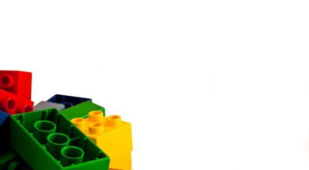 Plastic building blocks on white background. Bright colors.