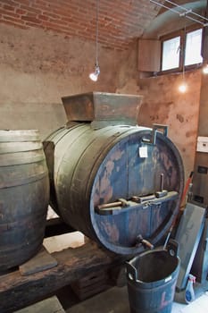 Old cellar with big barrels and bottles of wine